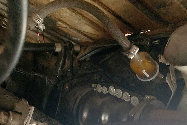 Relocate fuel filter behind firewall